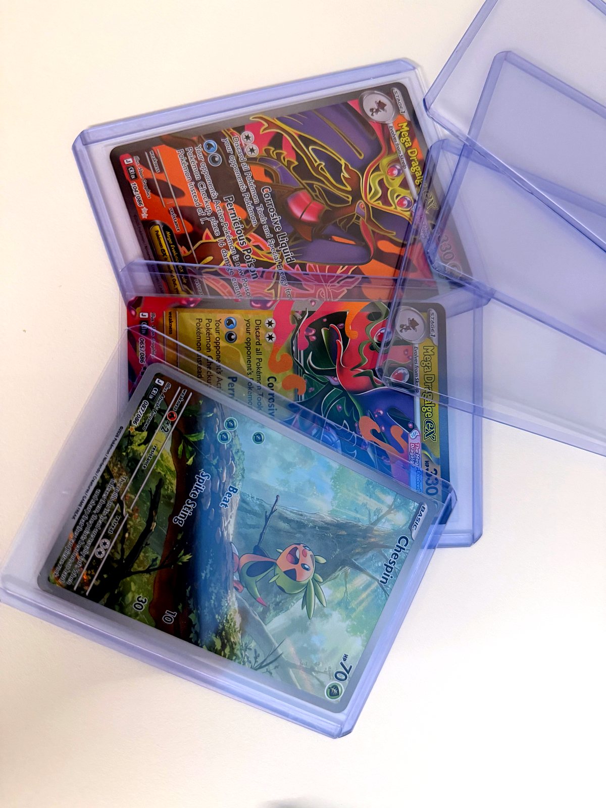 Sleeved card being slid into a toploader